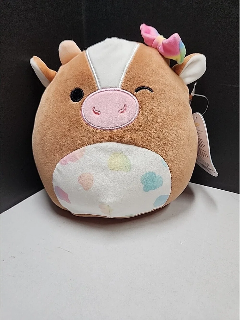 Squishmallows Griella the Winking Cow with Multi Color Bow Spots 7 Inch NEW NWT